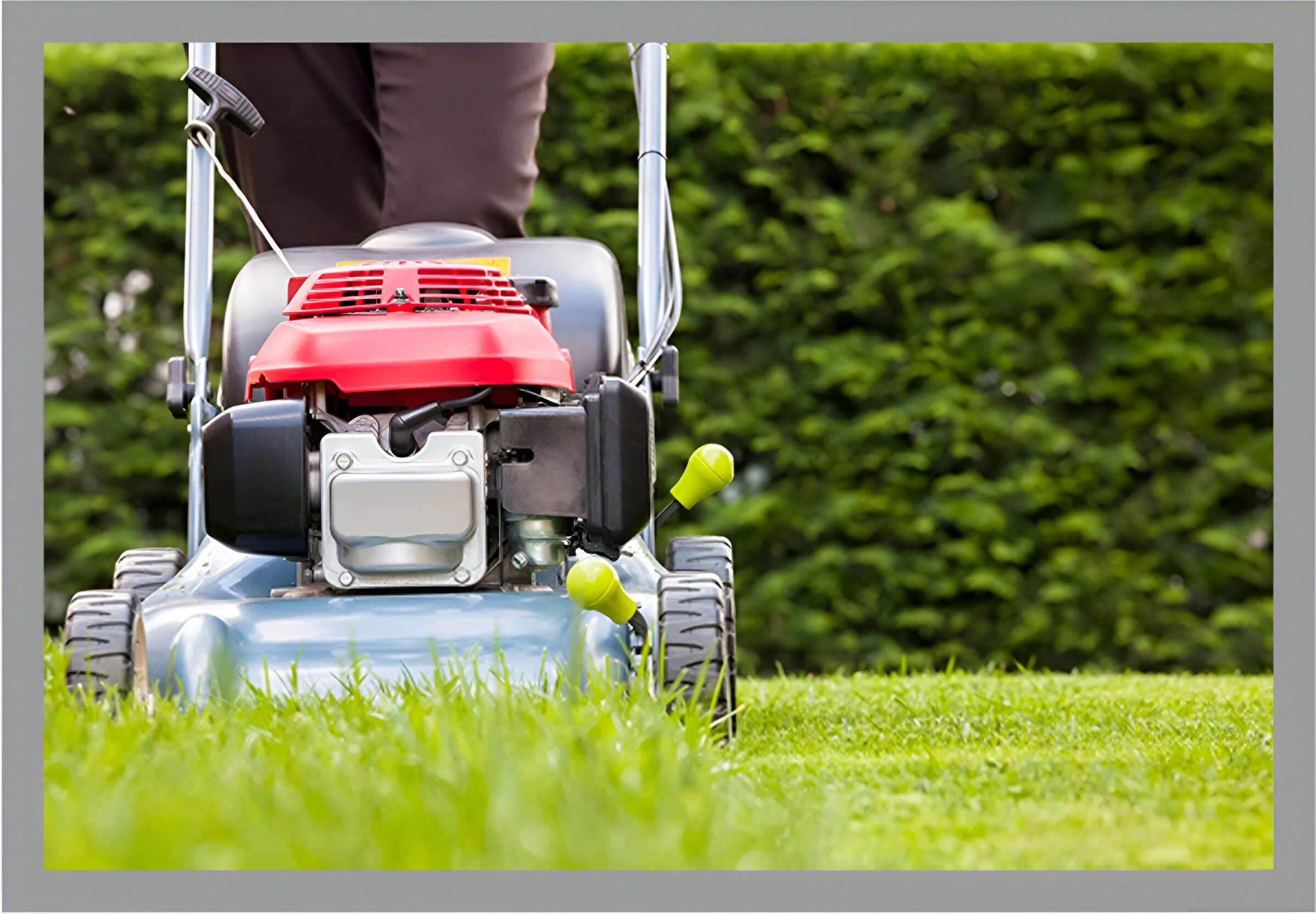 A person is using an electric lawn mower.