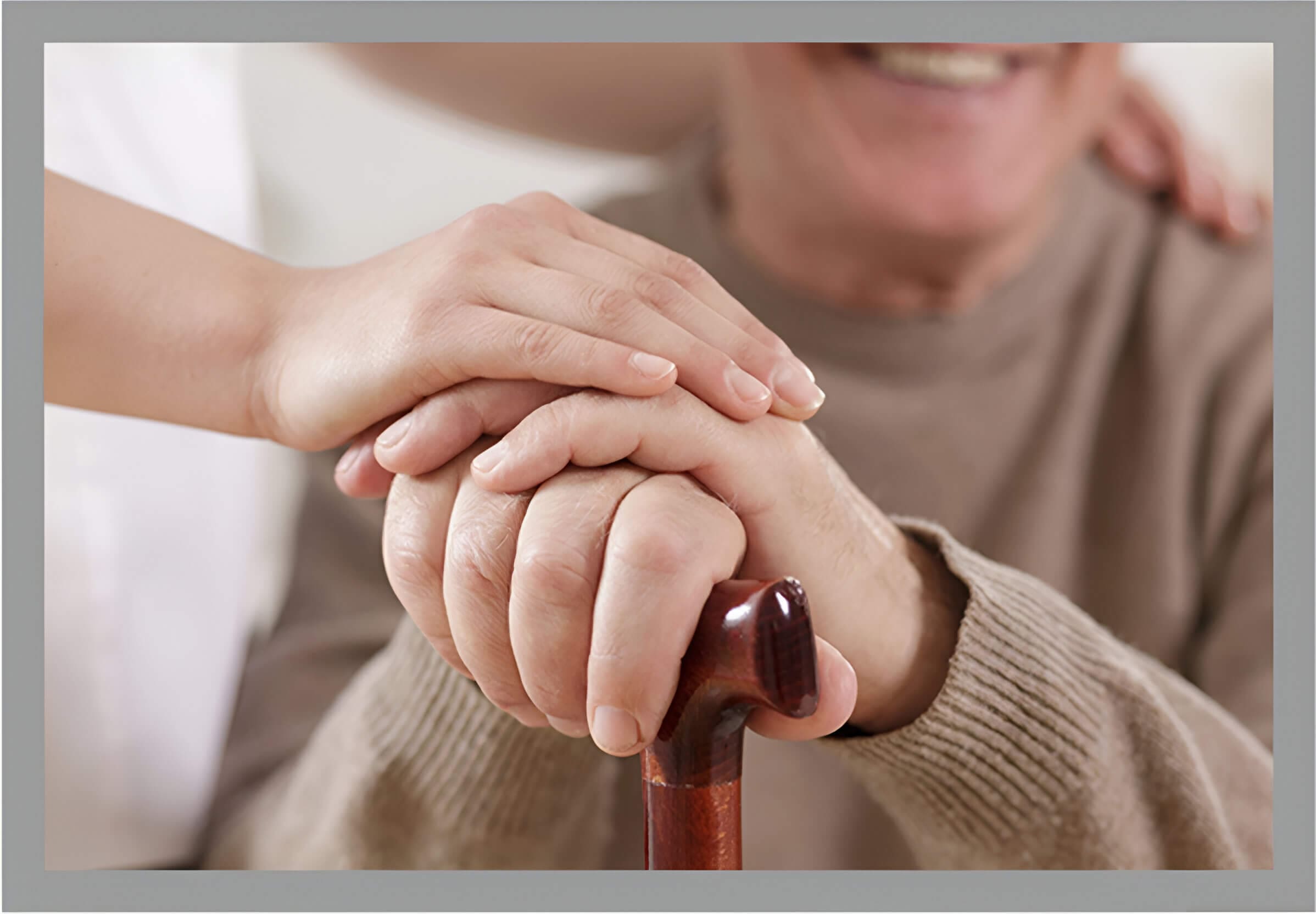 A person holding hands with another person on top of a cane.