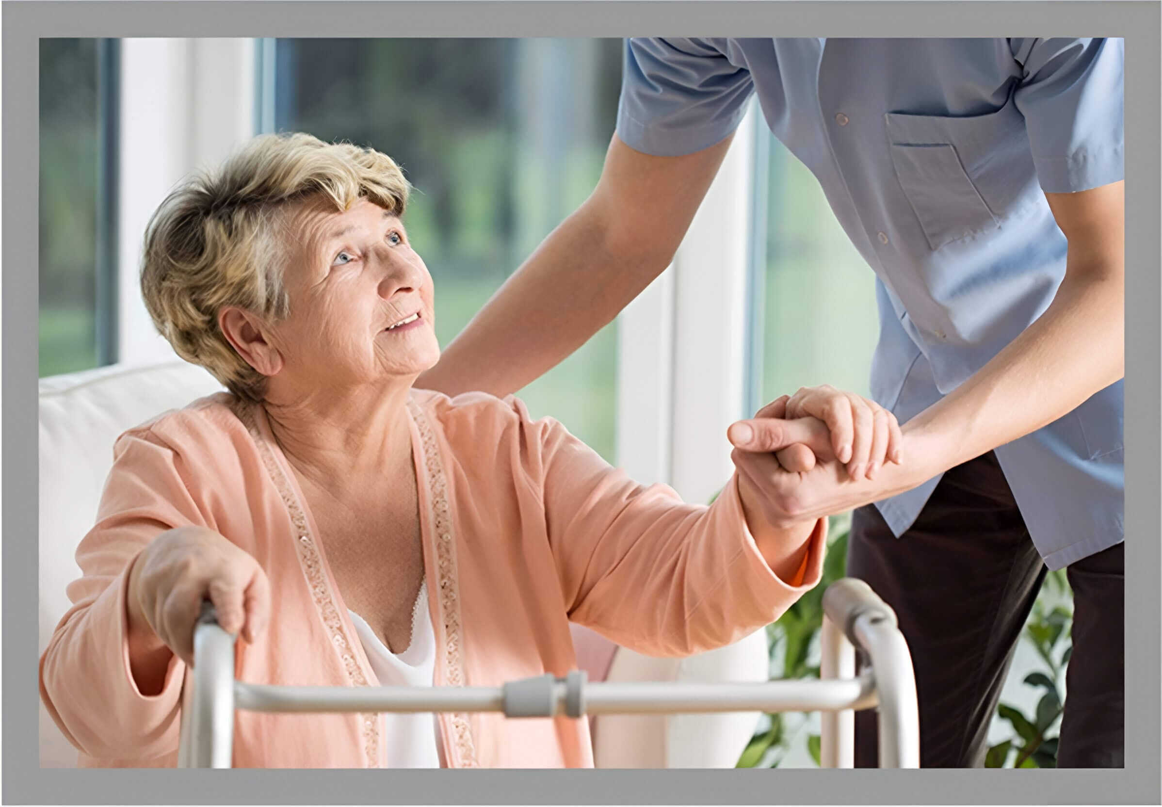 A woman in a pink shirt holding the hand of another person.