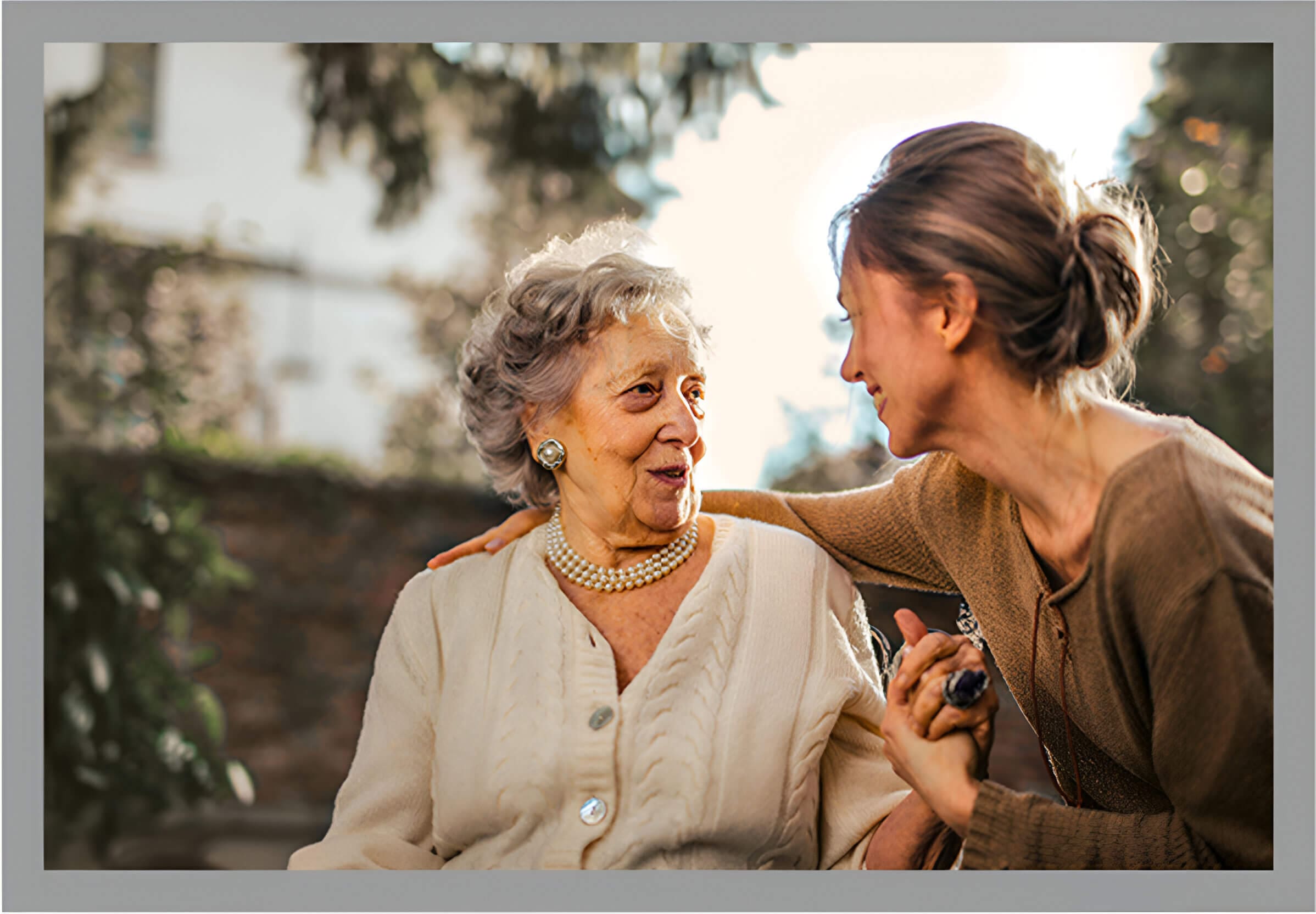 A woman is helping an older person with her hair.