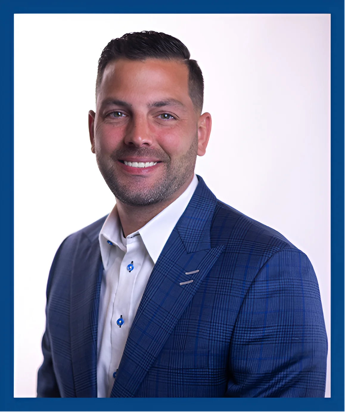 A man in a blue suit and white shirt.